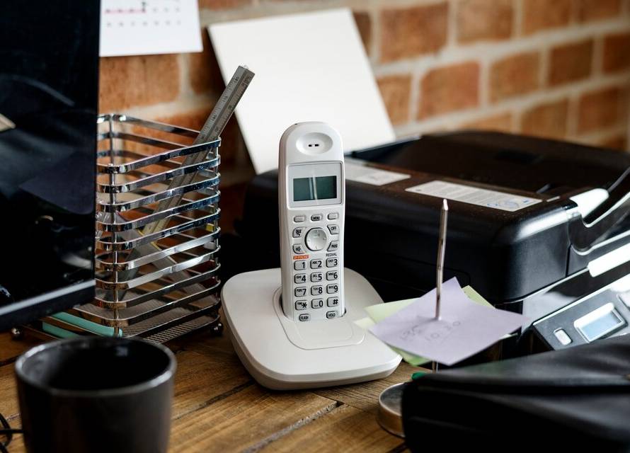 A VoIP phone adapter, connected to a telephone and internet source.